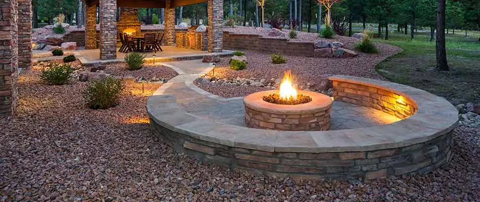 A fire pit in Millstadt, IL surrounded by landscape design and retaining walls.