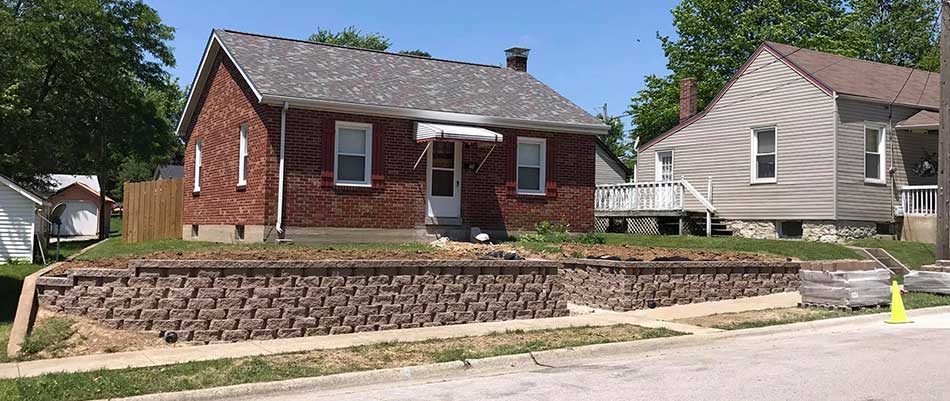 A retaining wall can help level out this residential yard in Waterloo, IL.
